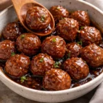 Meatballs with grape jelly and chili sauce served on a platter