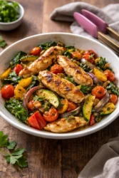 Colorful Mediterranean stir fry with fresh vegetables and spices in a skillet.