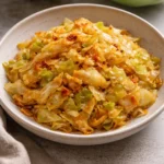 Delicious Paprika Sautéed Cabbage on a plate, garnished and ready to serve.