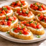 Whipped feta tomato crostini garnished with fresh herbs