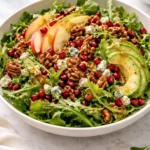 Winter Christmas salad with honey mustard dressing served in a bowl