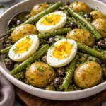 Zesty French-style potato salad with green beans in a bowl