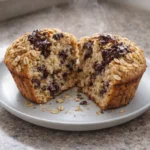 Freshly baked oatmeal chocolate chip muffins on a rustic table