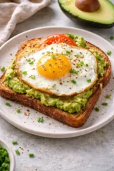 Delicious avocado-egg toast topped with fresh herbs and spices