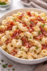 Creamy Bacon Cheddar Ranch Pasta Salad served in a bowl with bacon and cheese