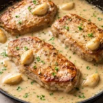 Creamy garlic pork chops served with side vegetables