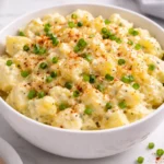 Creamy potato salad served in a bowl with fresh herbs