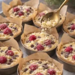 Delicious raspberry chocolate chip muffins with a crunchy crumble topping