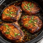 Plate of slow cooker honey garlic pork chops with vegetables