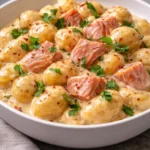 Plate of creamy smoked salmon gnocchi garnished with herbs