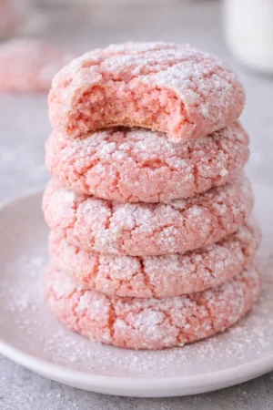 Strawberry Cake Mix Crinkle Cookies on a plate with powdered sugar