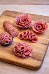 Different salami folding techniques displayed for charcuterie board decoration