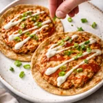 Buffalo smashed chicken tacos served with fresh toppings and sauces
