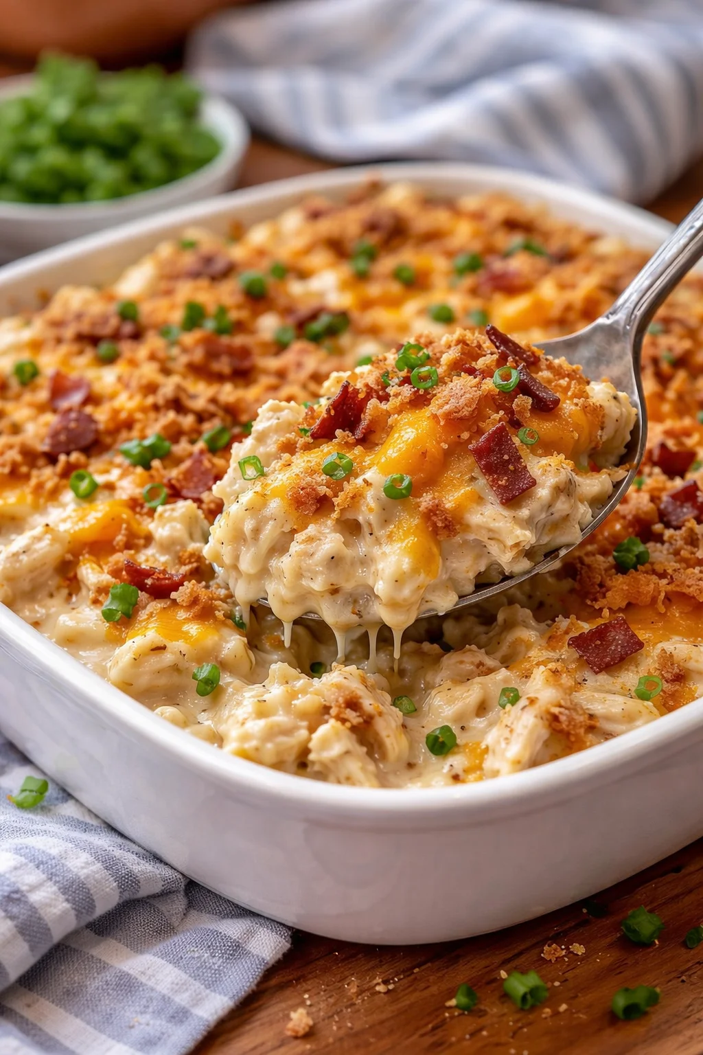 Creamy Crack Chicken Casserole topped with herbs in a baking dish