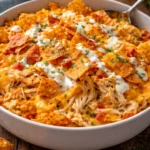 Delicious Doritos Cheesy Chicken Casserole topped with crunchy chips and cheese