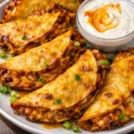 Delicious baked buffalo chicken tacos topped with cheese and fresh toppings