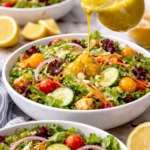 Homemade Lemon Vinaigrette Dressing served in a glass jar with salad ingredients