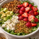 A vibrant Strawberry Crunch Salad with Champagne Vinaigrette served in a bowl.