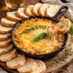 Caramelized onion cheese dip served in a bowl with chips on the side